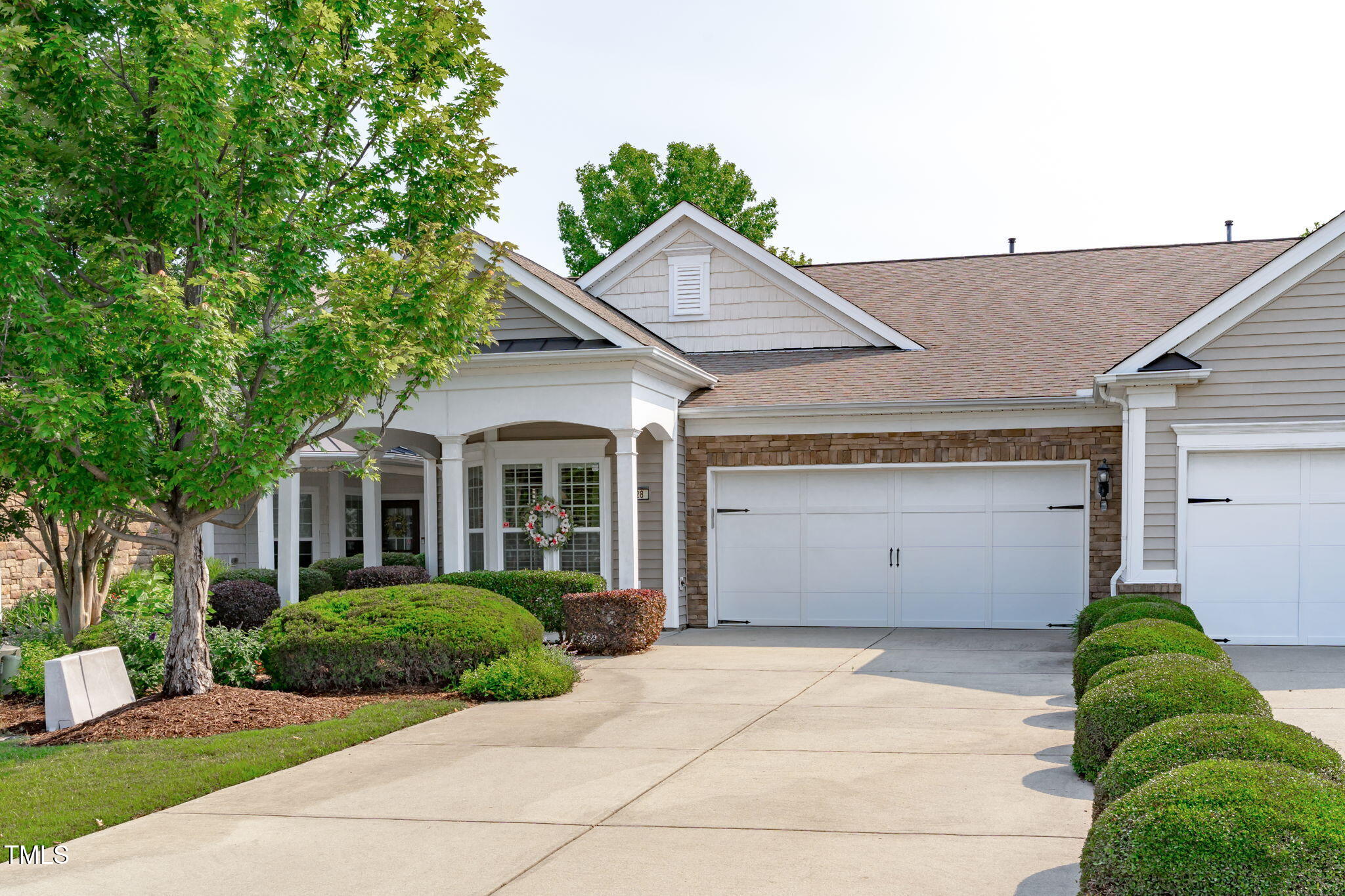 128 Arvind Oaks Circle Cary, NC 27519 - Photo 33 of 34 a view of a white house with a yard and potted plants