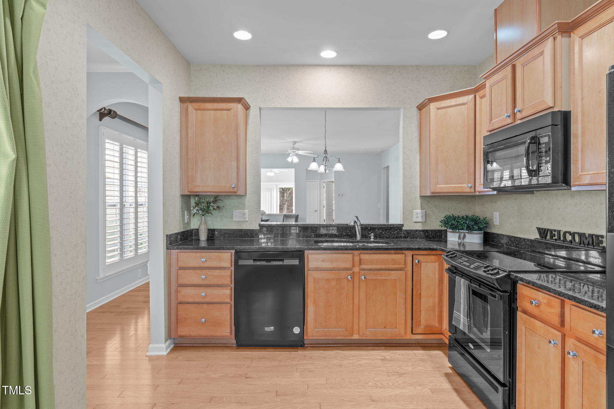 128 Arvind Oaks Circle Cary, NC 27519 - Photo 4 of 34 a kitchen with stainless steel appliances granite countertop a stove a sink and a microwave