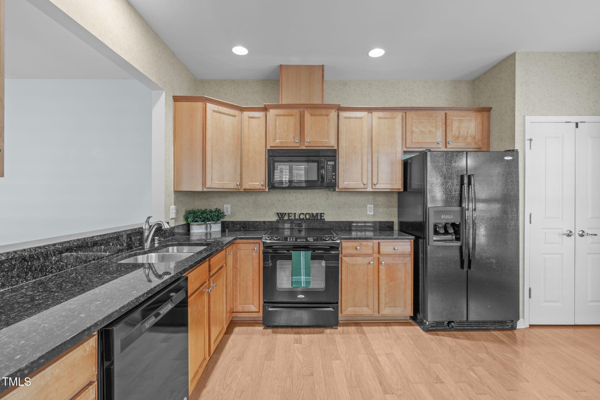 128 Arvind Oaks Circle Cary, NC 27519 - Photo 9 of 34 a kitchen with stainless steel appliances granite countertop a stove a refrigerator and a sink