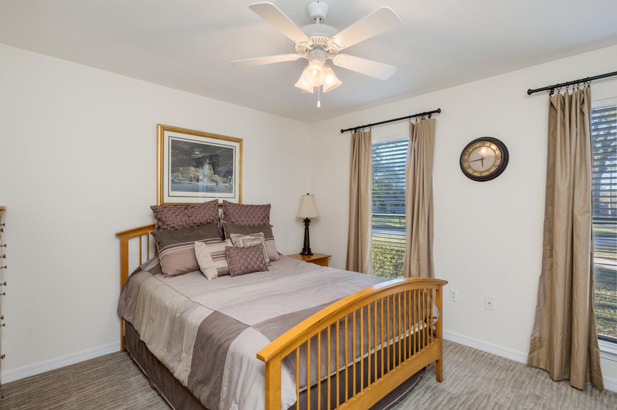 191 Adams Drive Crestview, FL 32536 - Photo 11 of 29 a bedroom with a bed and a clock on the wall