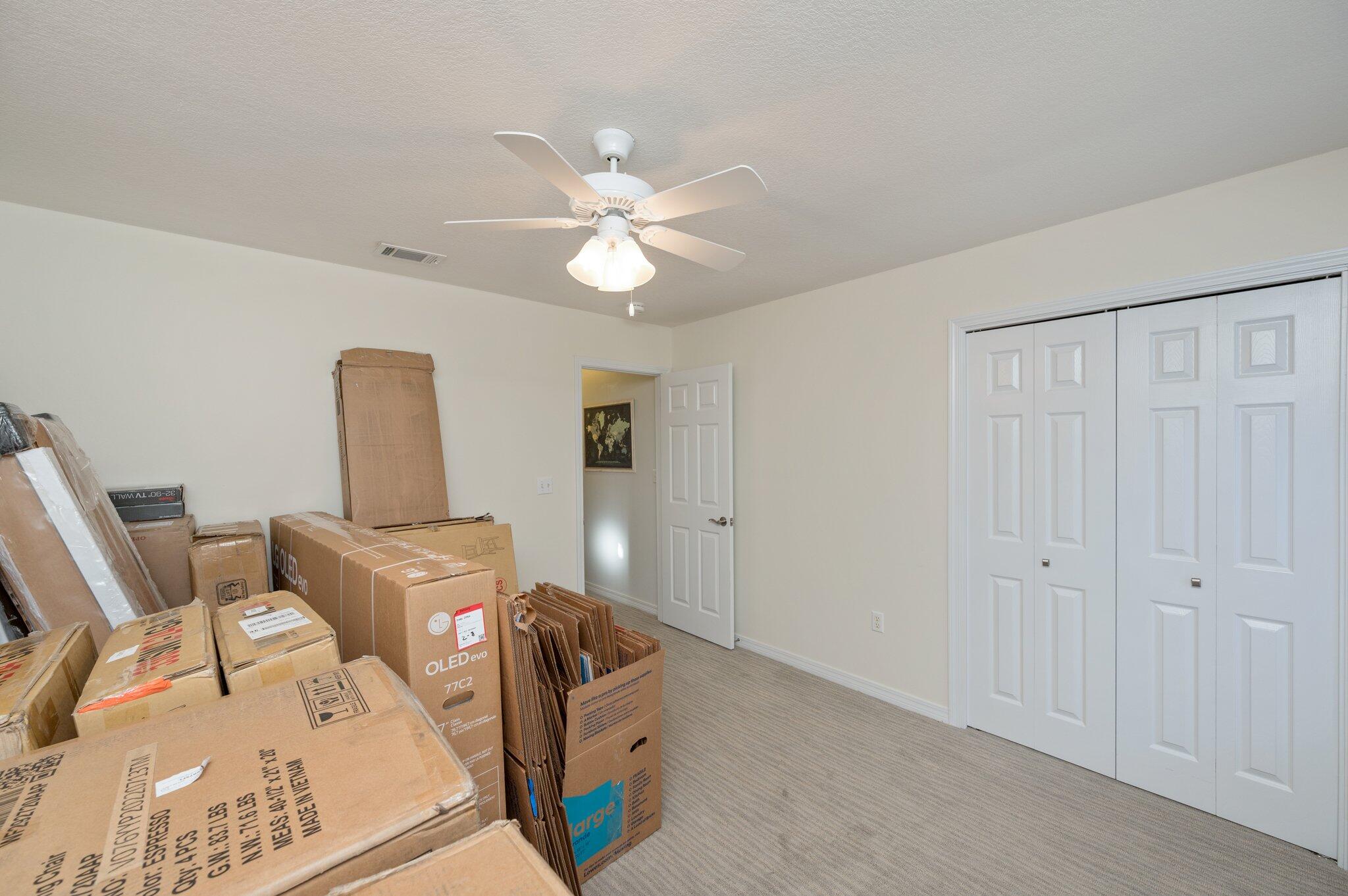 191 Adams Drive Crestview, FL 32536 - Photo 16 of 29 a bedroom with furniture and a chandelier fan