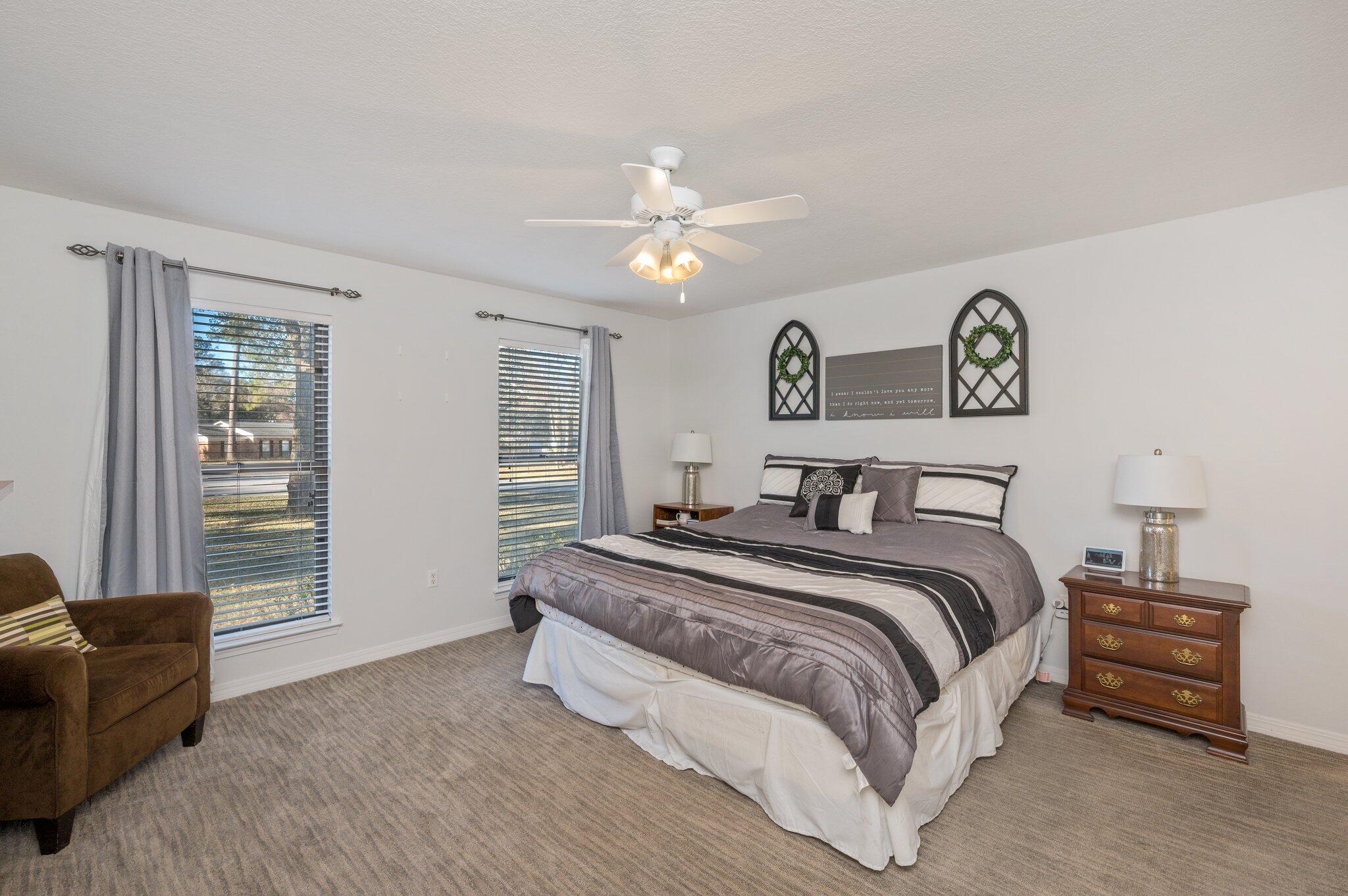 191 Adams Drive Crestview, FL 32536 - Photo 17 of 29 a spacious bedroom with a bed and a couch