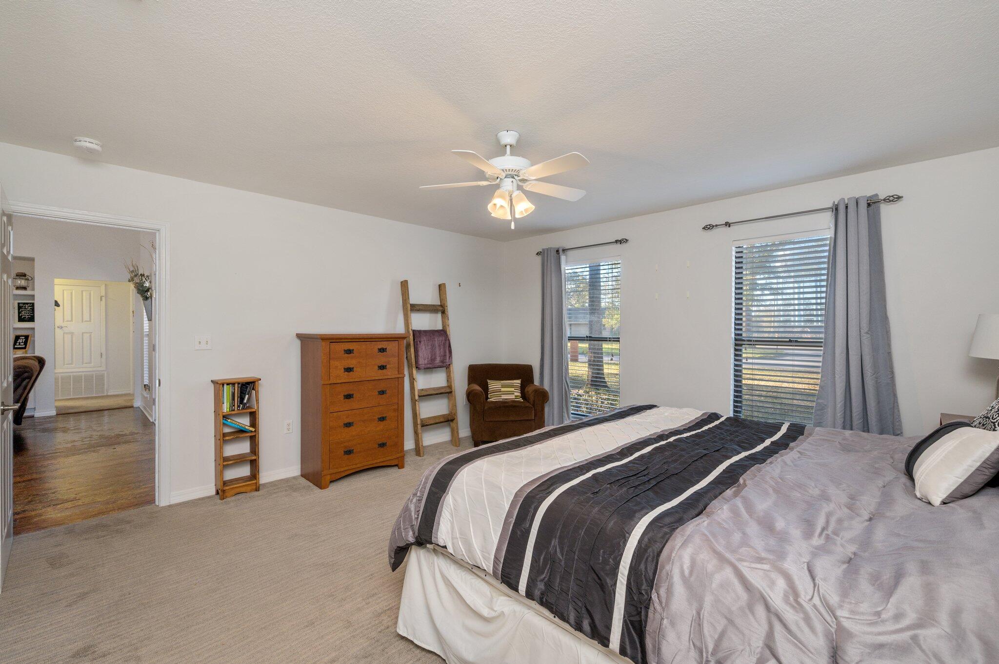 191 Adams Drive Crestview, FL 32536 - Photo 18 of 29 a bedroom with a bed and a chandelier