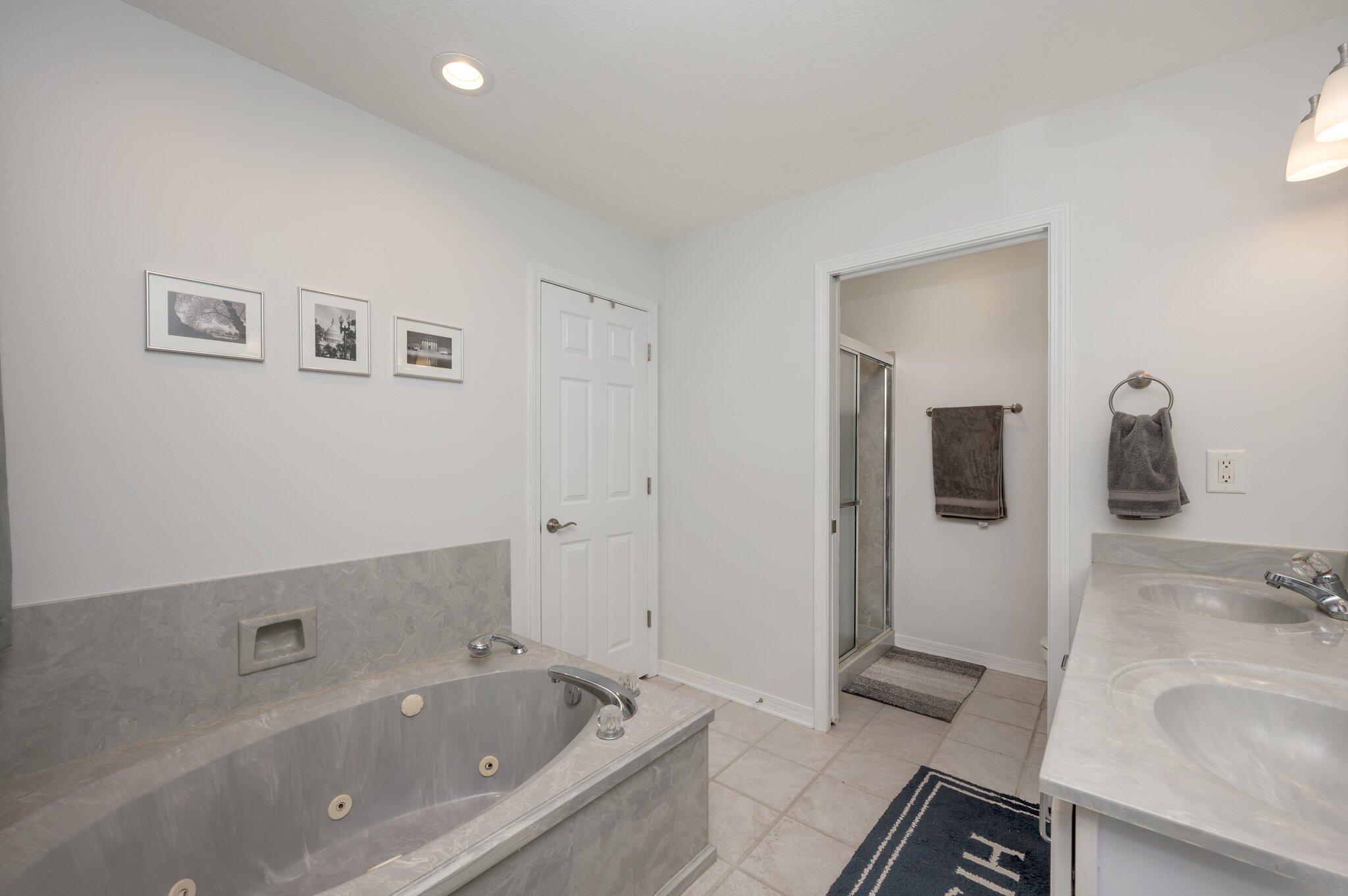 191 Adams Drive Crestview, FL 32536 - Photo 19 of 29 a bathroom with a tub sink and mirror