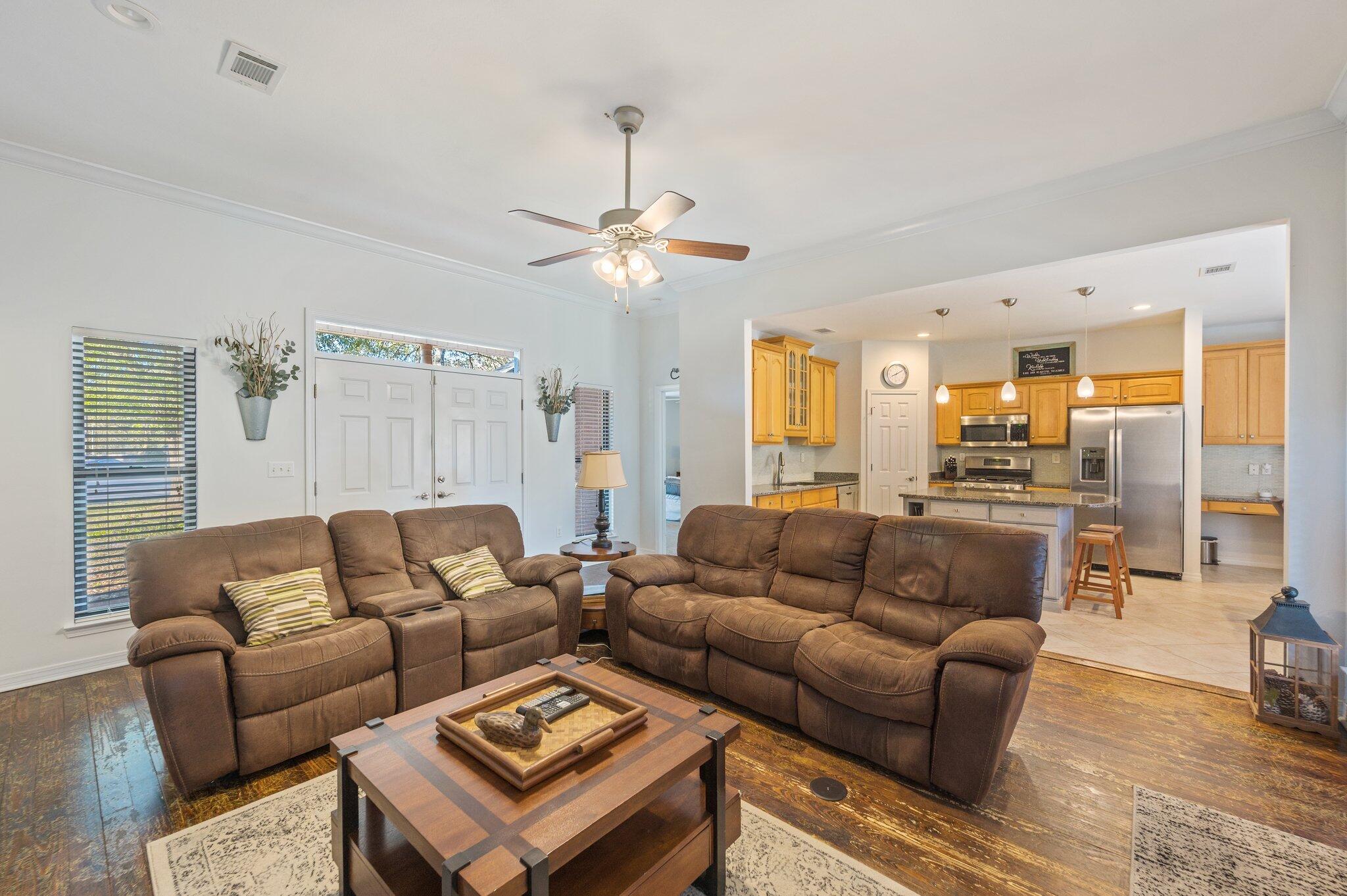 191 Adams Drive Crestview, FL 32536 - Photo 6 of 29 a living room with furniture kitchen view and a chandelier
