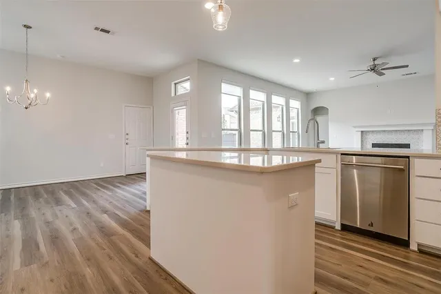 a kitchen with kitchen island a sink appliances and cabinets