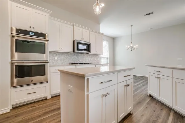 a kitchen with granite countertop cabinets and steel stainless steel appliances