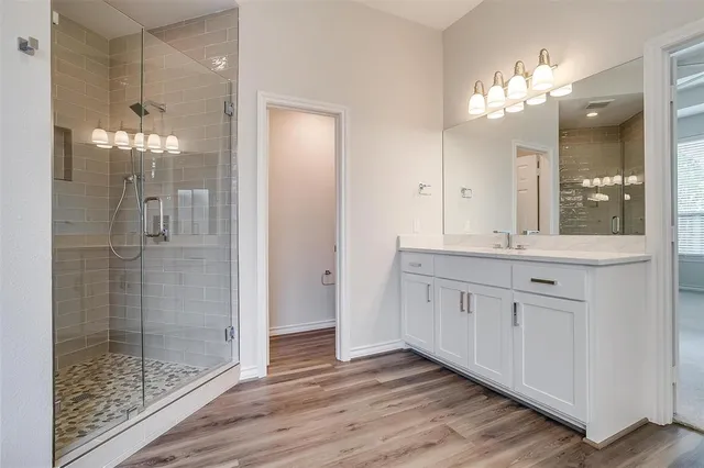 a bathroom with a double vanity sink and a mirror