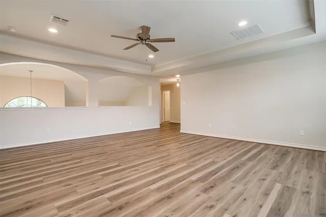 a view of empty room with wooden floor
