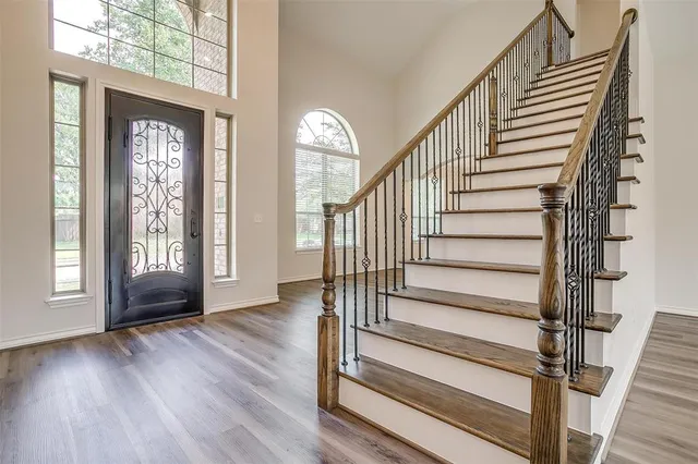 a view of entryway with wooden floor and front door