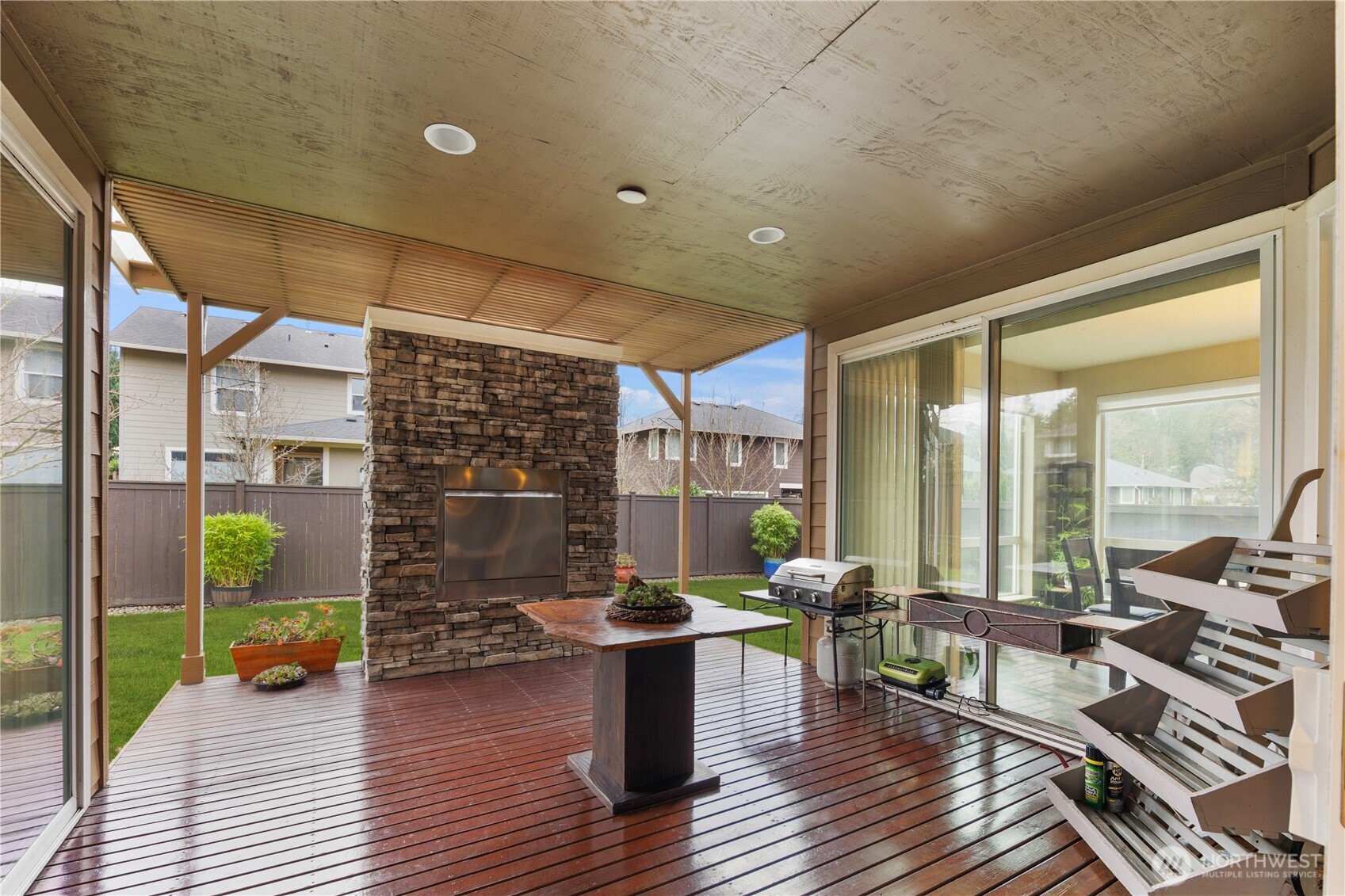 5627 South 336th Place Auburn, WA 98001 - Photo 13 of 40 a living room with fireplace furniture and a floor to ceiling window