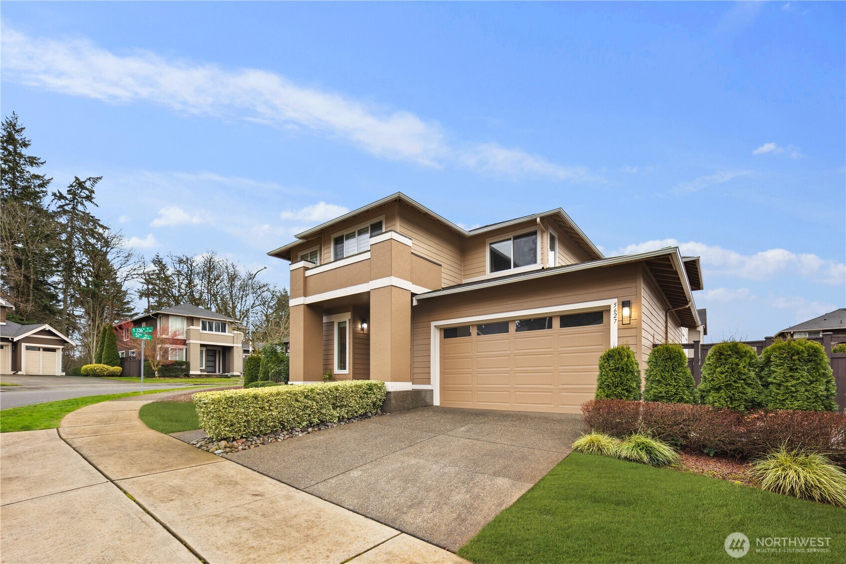 5627 South 336th Place Auburn, WA 98001 - Photo 3 of 40 a front view of a house with a yard and garage