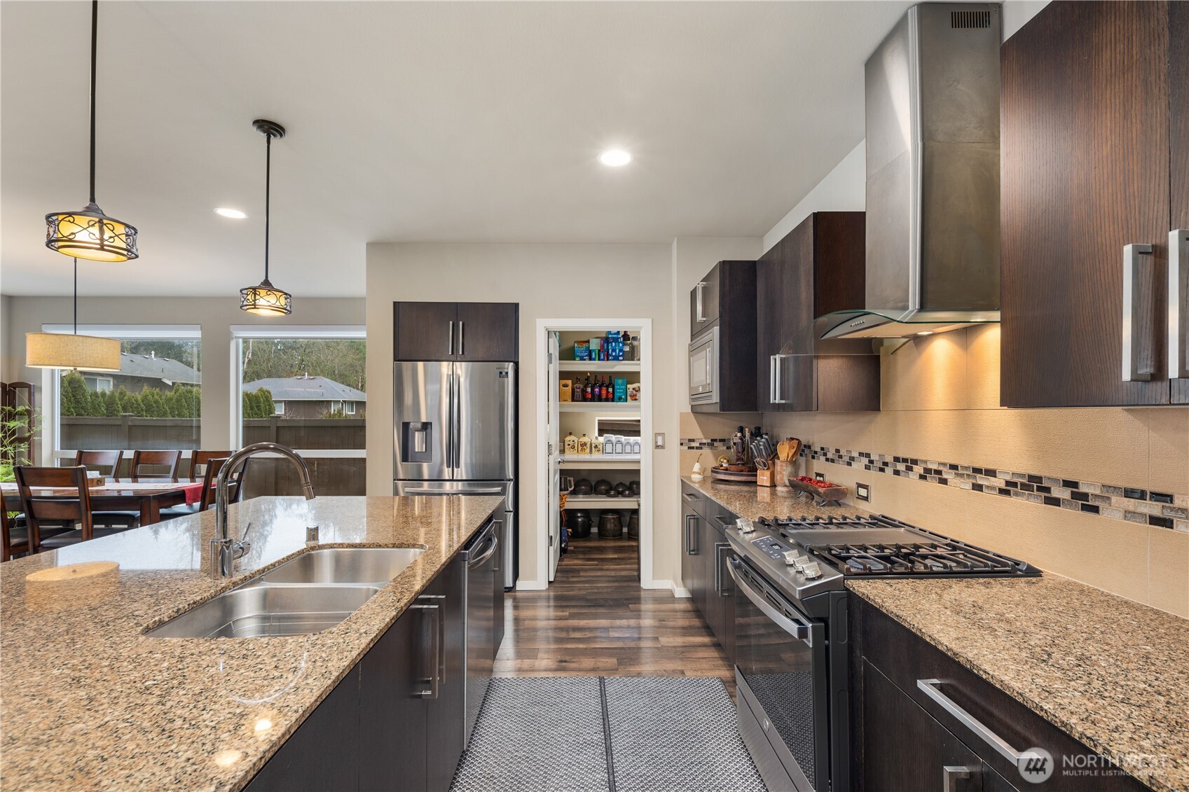 5627 South 336th Place Auburn, WA 98001 - Photo 7 of 40 a kitchen with stainless steel appliances granite countertop a sink stove and refrigerator