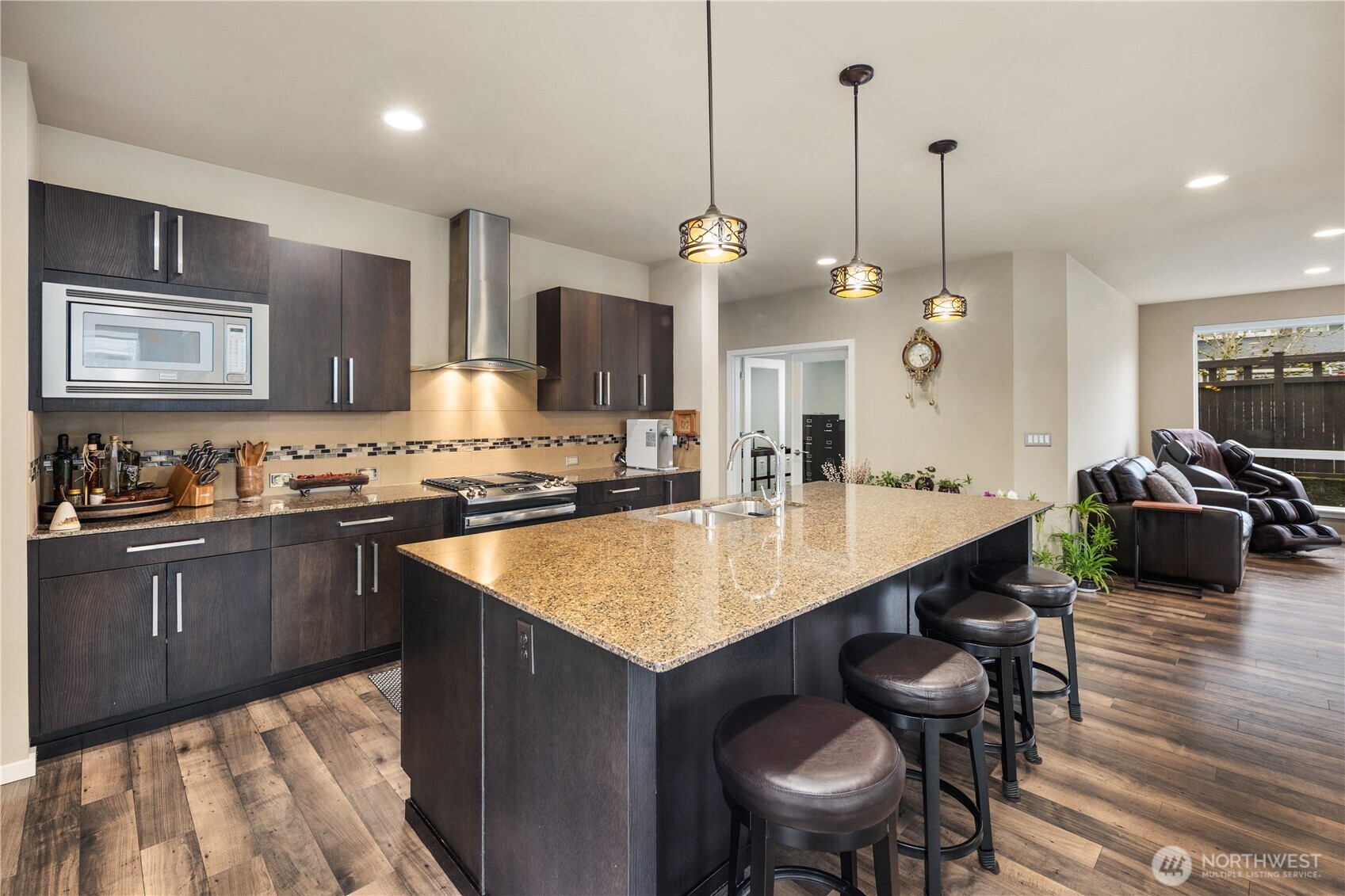 5627 South 336th Place Auburn, WA 98001 - Photo 8 of 40 a kitchen with a sink a counter and chairs