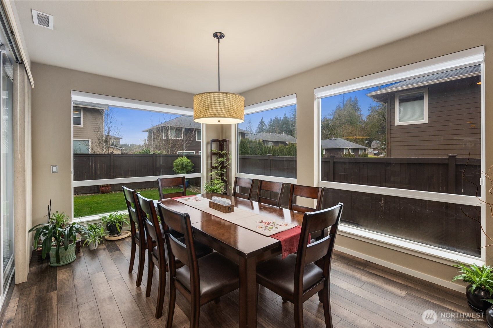 5627 South 336th Place Auburn, WA 98001 - Photo 10 of 40 a view of a dining room with furniture window and wooden floor