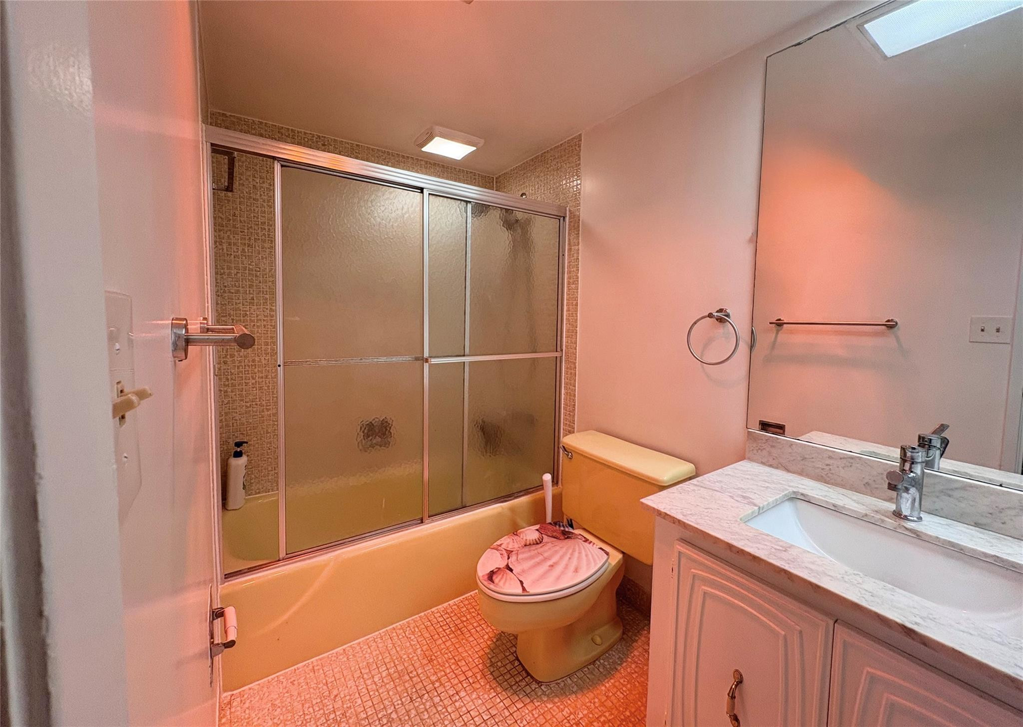 2601 South Course Drive, Unit 406 Pompano Beach, FL 33069 - Photo 11 of 15 a bathroom with a granite countertop sink a toilet and shower