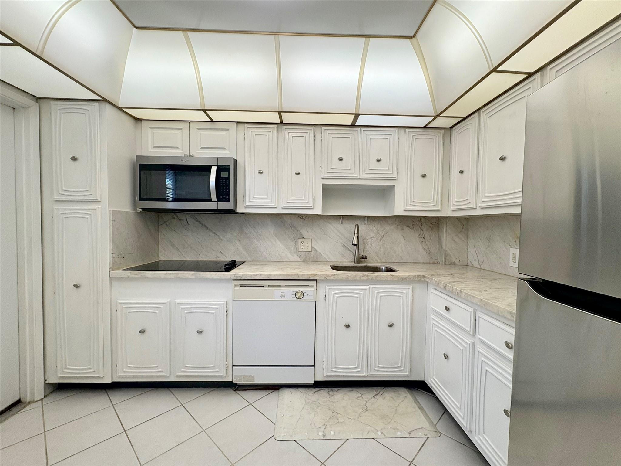 2601 South Course Drive, Unit 406 Pompano Beach, FL 33069 - Photo 3 of 15 a kitchen with stainless steel appliances granite countertop a sink a stove and cabinets