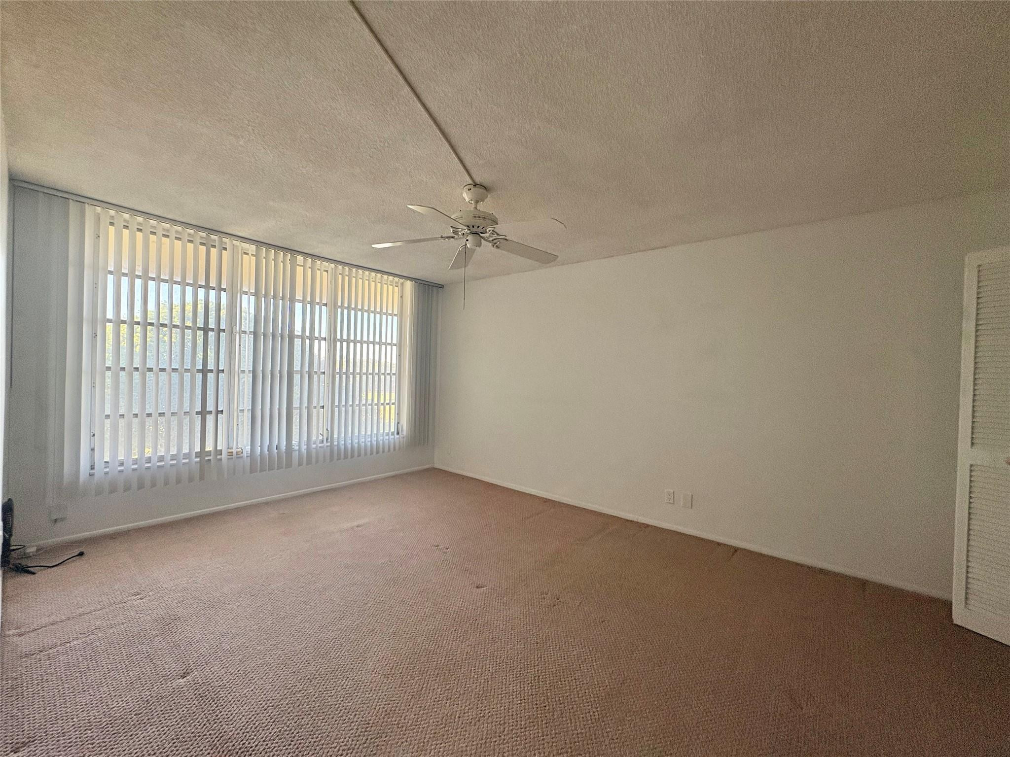 2601 South Course Drive, Unit 406 Pompano Beach, FL 33069 - Photo 7 of 15 en empty room with windows