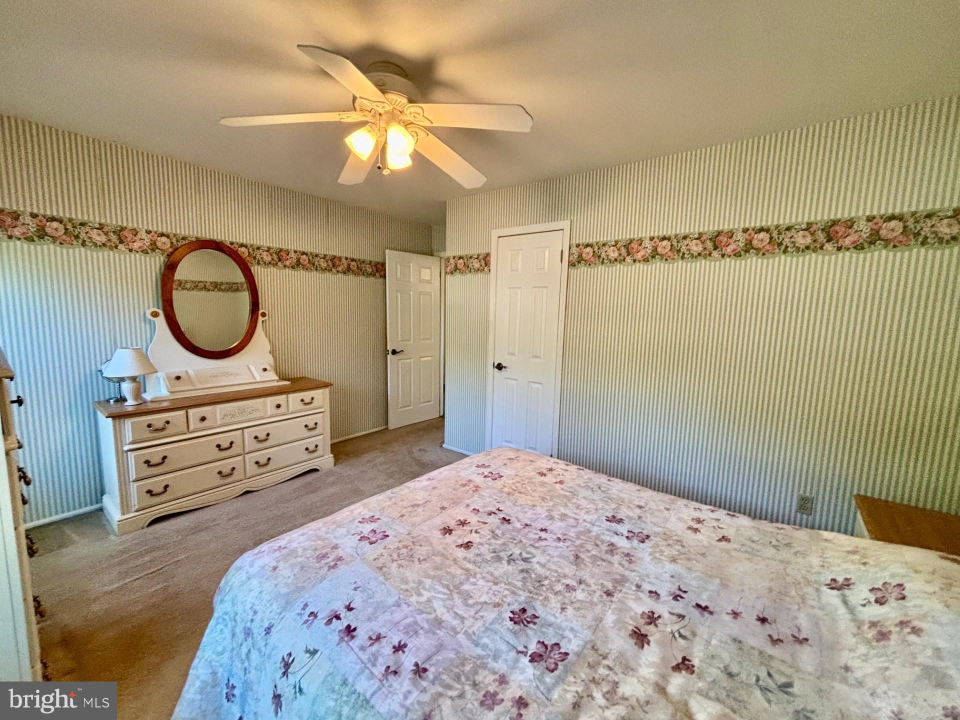 20 Bock Boulevard Howell, NJ 07731 - Photo 24 of 32 a bedroom with a bed a dresser and a chandelier