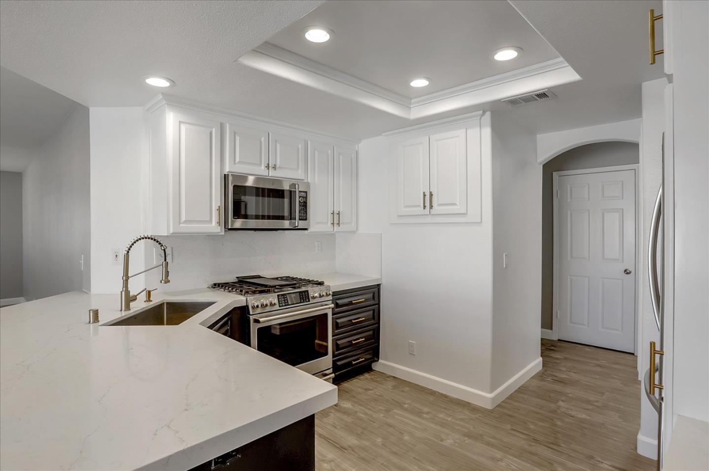 25307 Carson Way Stevenson Ranch, CA 91381 - Photo 13 of 36 a kitchen with granite countertop a stove and a sink