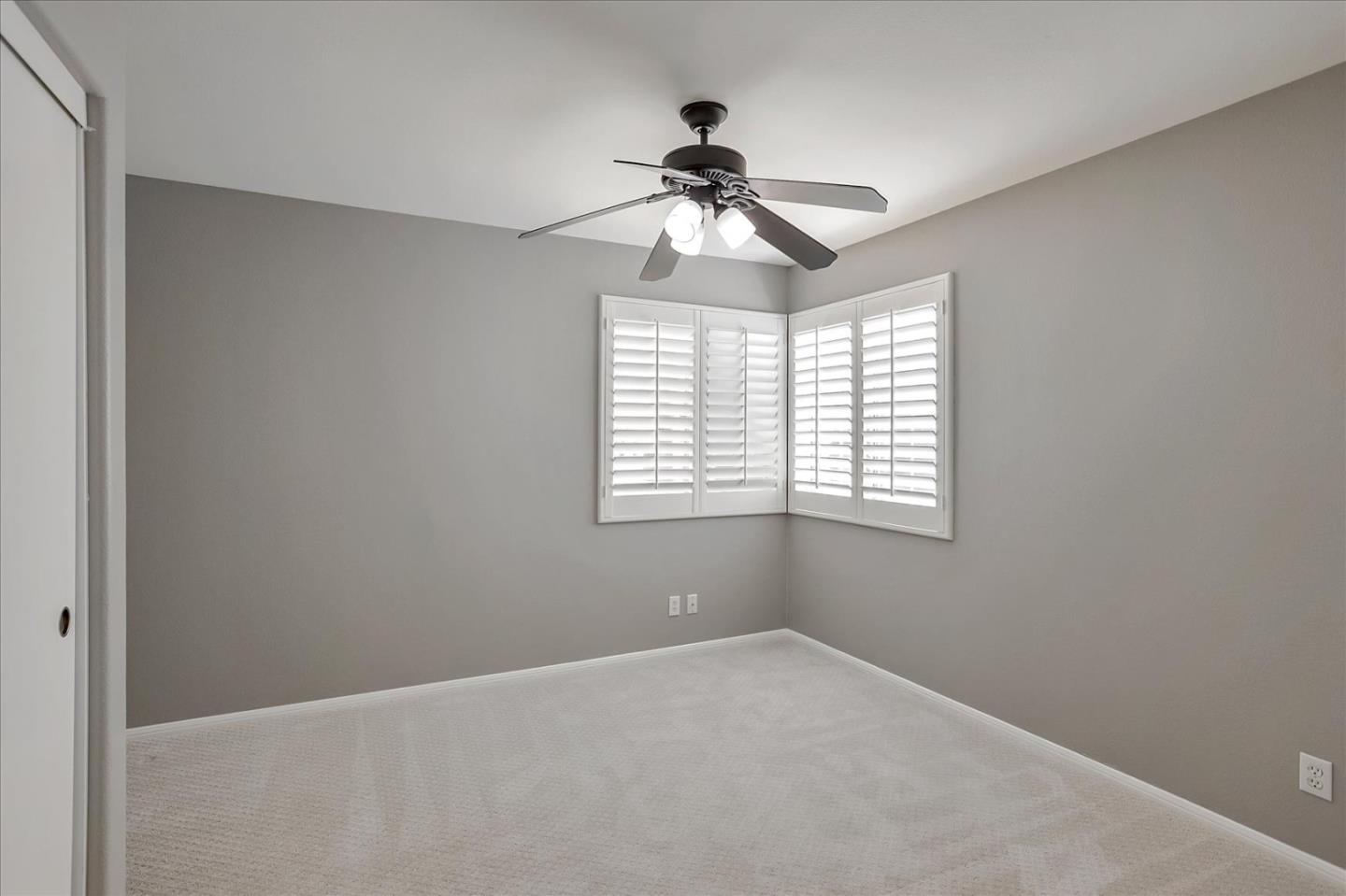 25307 Carson Way Stevenson Ranch, CA 91381 - Photo 21 of 36 en empty room with windows and chandelier fan