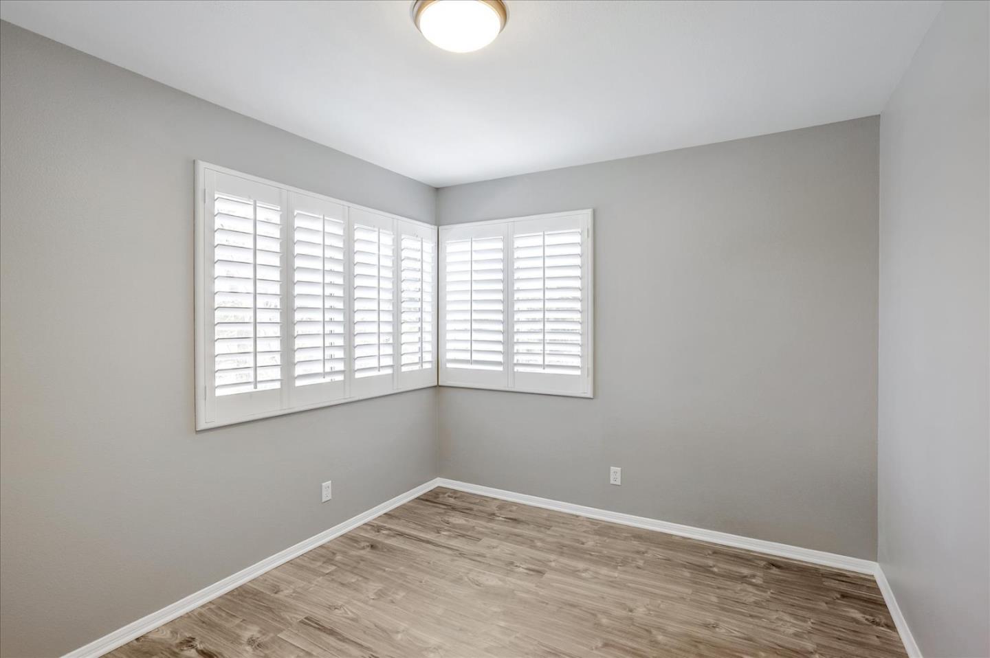 25307 Carson Way Stevenson Ranch, CA 91381 - Photo 26 of 36 a view of an empty room with wooden floor and a window