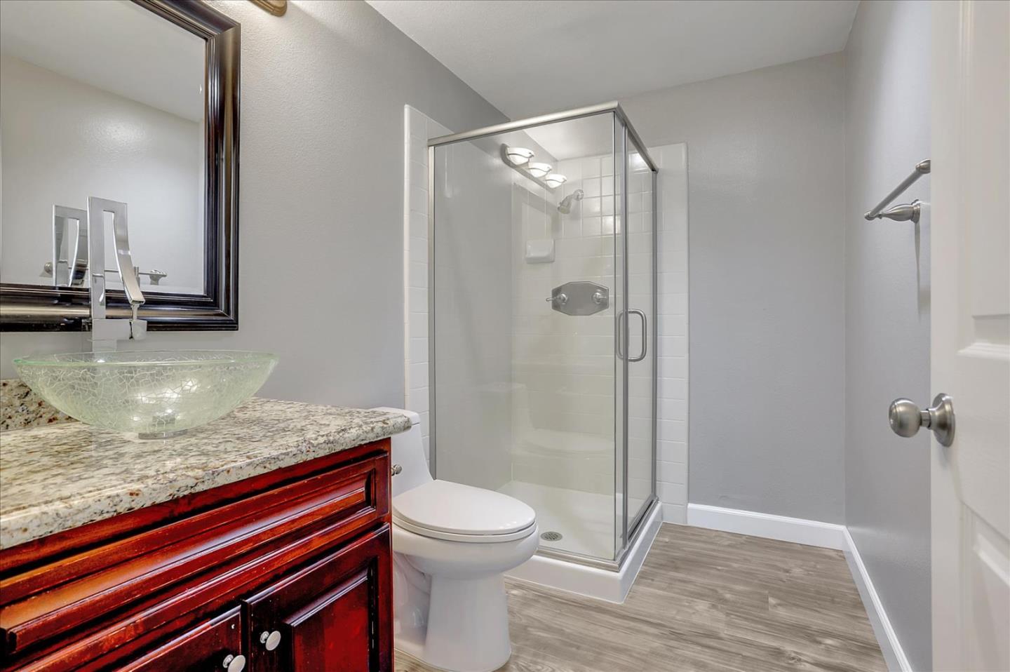 25307 Carson Way Stevenson Ranch, CA 91381 - Photo 28 of 36 a bathroom with a granite countertop sink toilet and shower