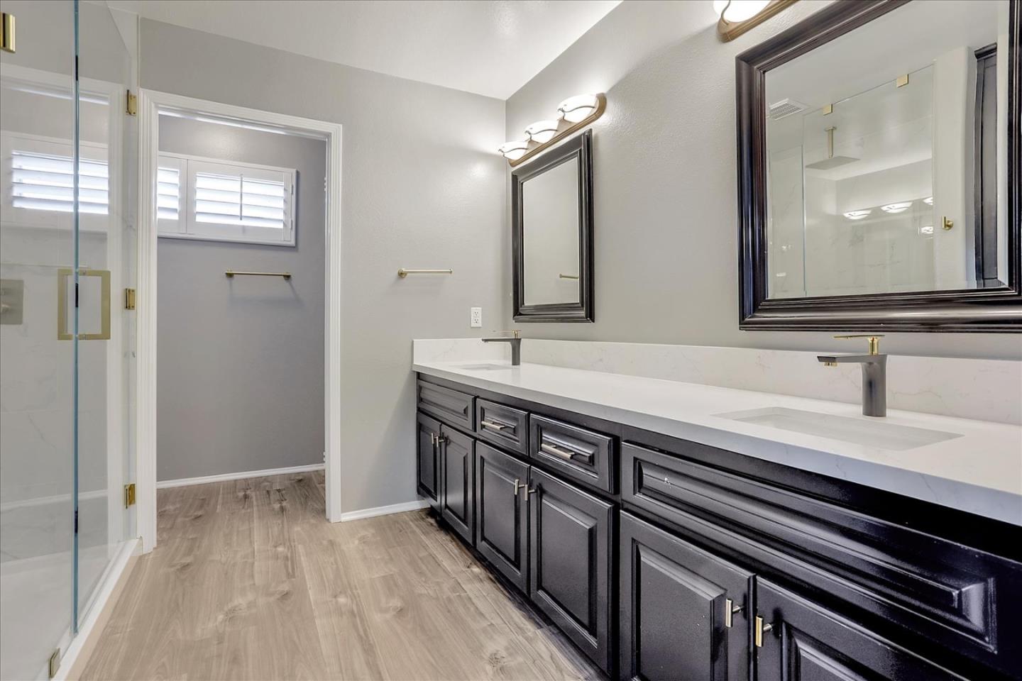 25307 Carson Way Stevenson Ranch, CA 91381 - Photo 30 of 36 a bathroom with a sink a mirror and a shower