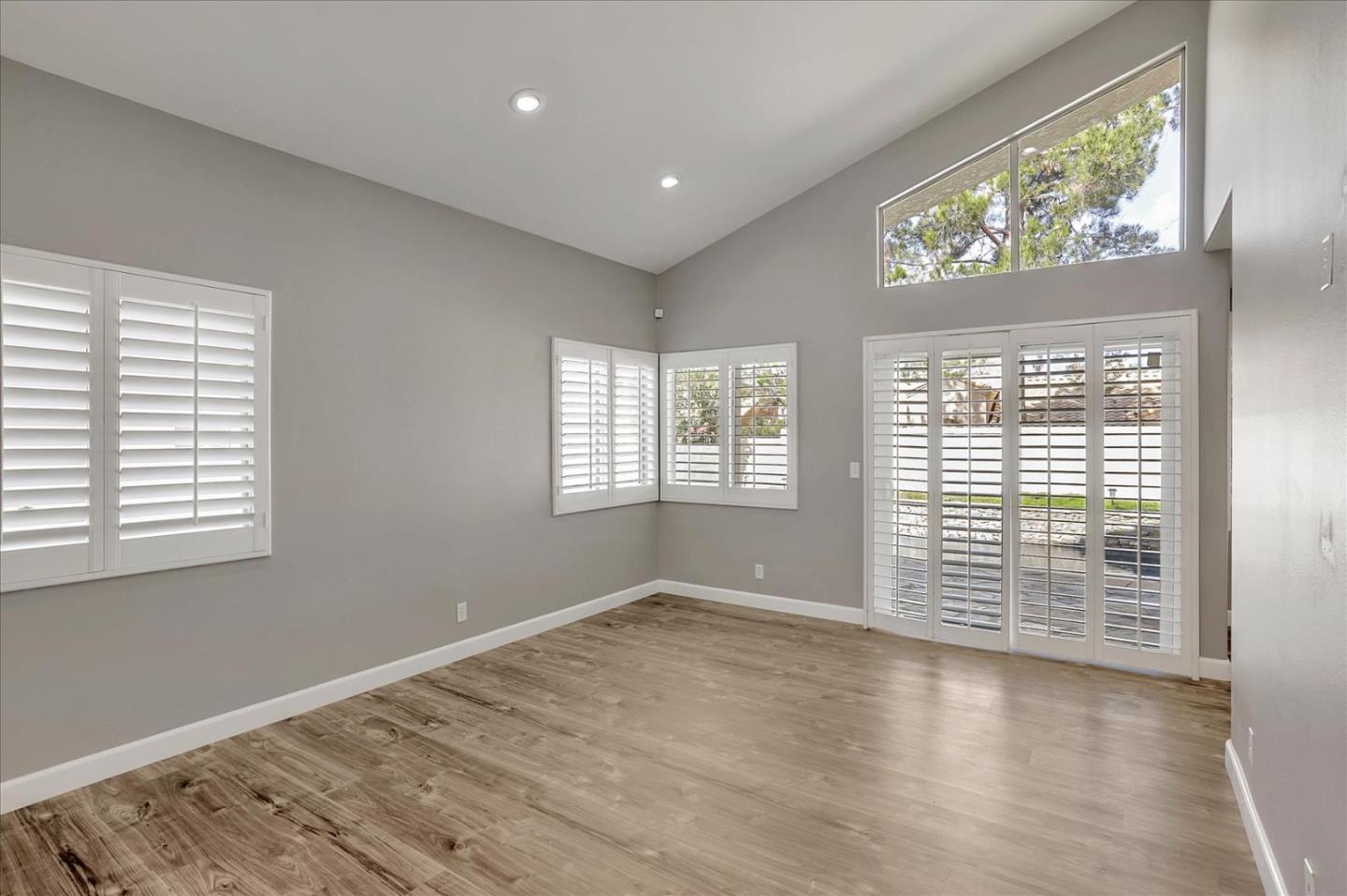25307 Carson Way Stevenson Ranch, CA 91381 - Photo 6 of 36 a view of an empty room with wooden floor and a window