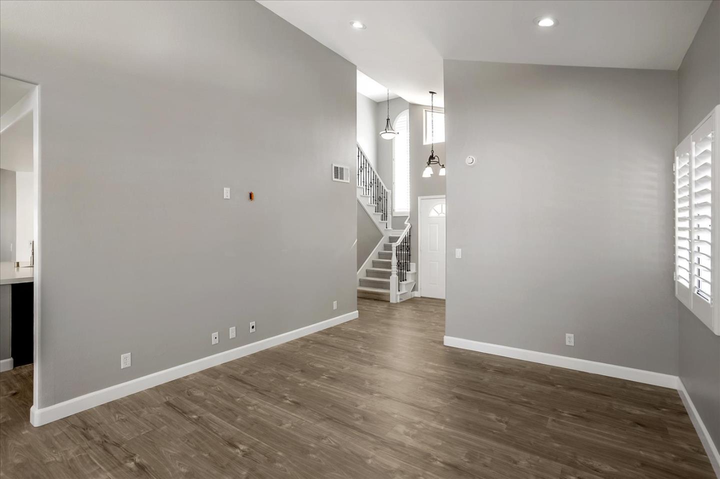 25307 Carson Way Stevenson Ranch, CA 91381 - Photo 8 of 36 a view of an empty room with wooden floor and a window