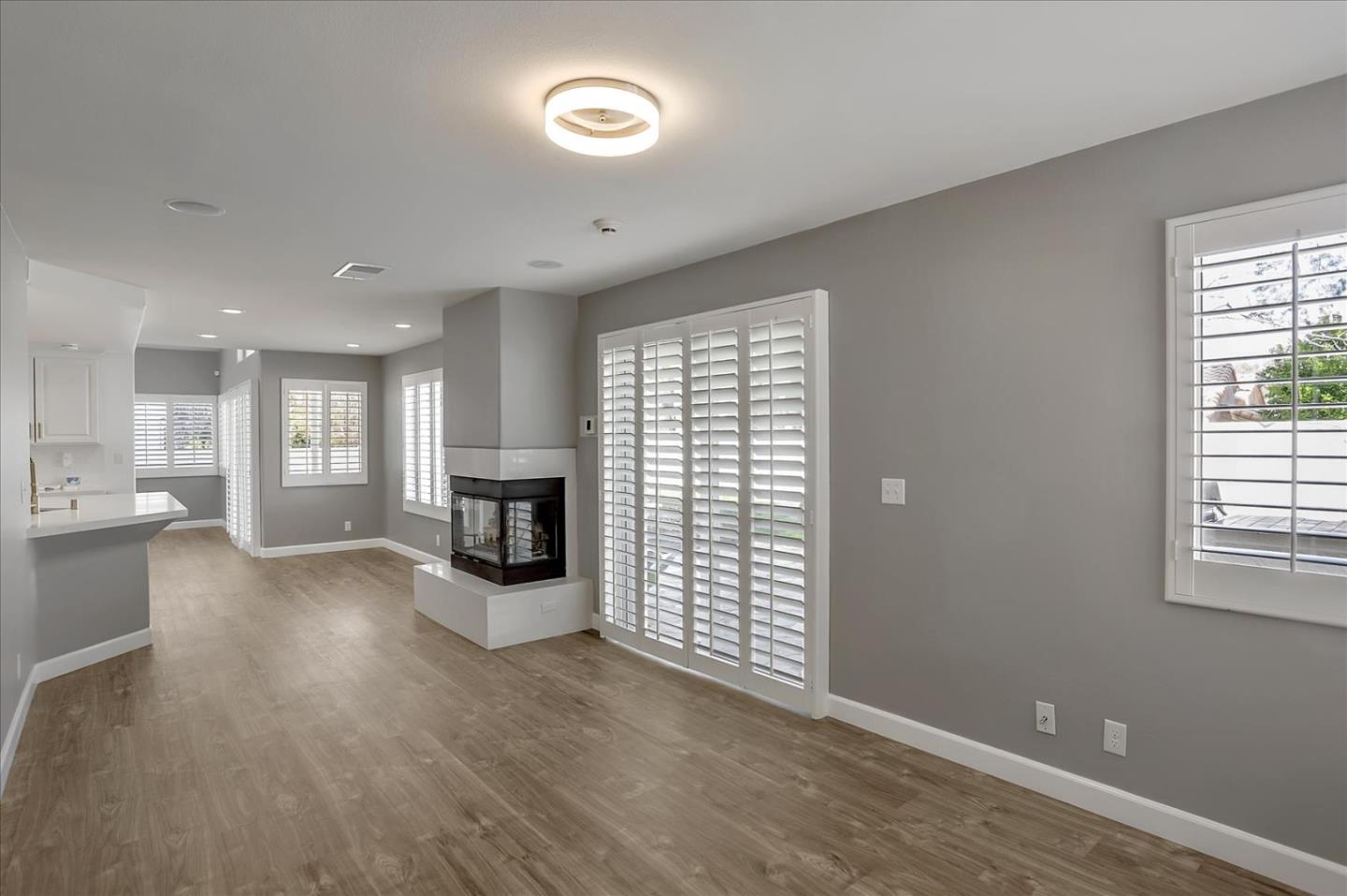 25307 Carson Way Stevenson Ranch, CA 91381 - Photo 9 of 36 an empty room with wooden floor and fireplace