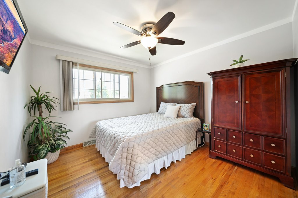 365 West Myrick Avenue Addison, IL 60101 - Photo 25 of 49 a bedroom with bed and wooden floor