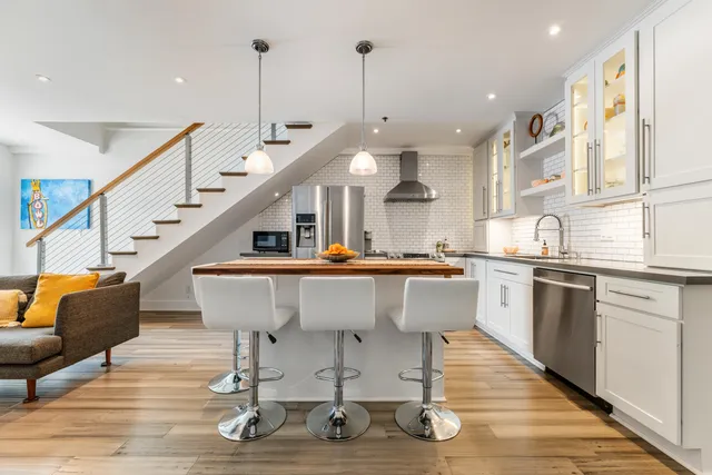 a view of kitchen with stainless steel appliances granite countertop cabinets table and chairs