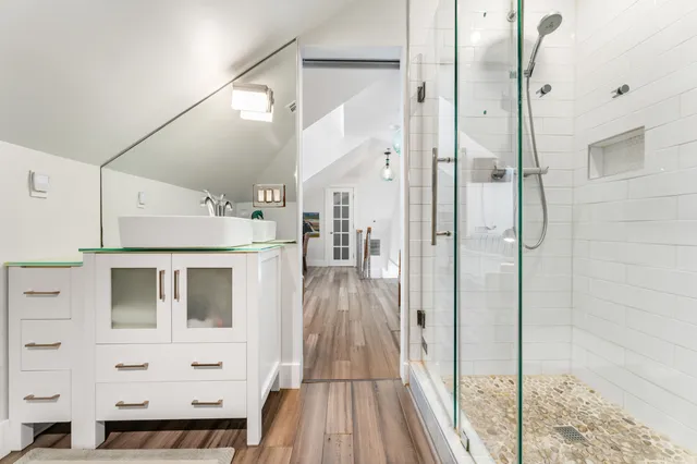 a view of a hallway with wooden floor and glass door