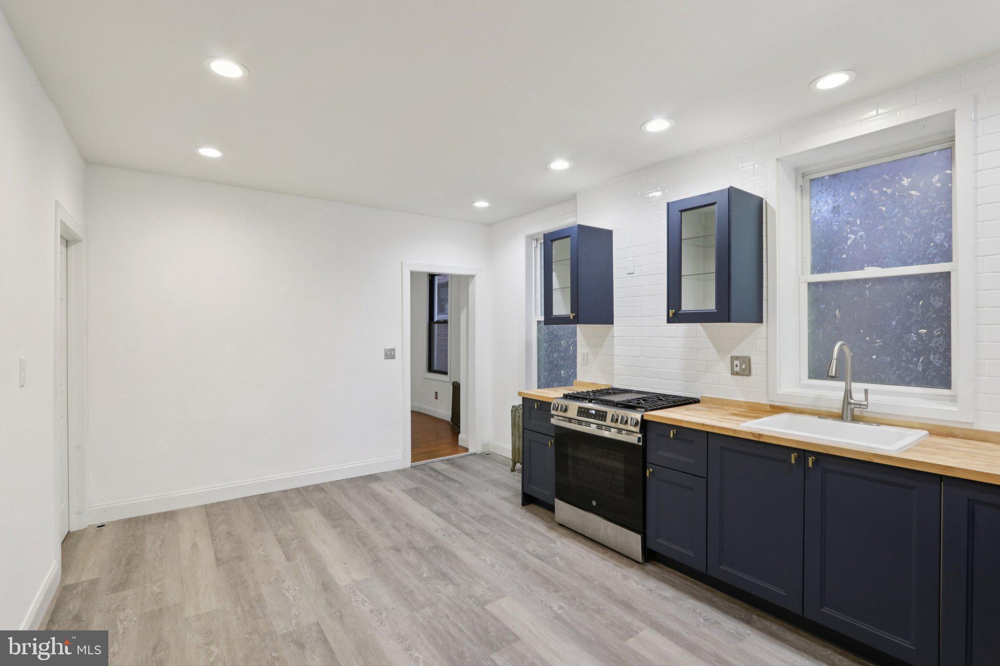 508 South 49th Street Philadelphia, PA 19143 - Photo 15 of 51 a kitchen with stainless steel appliances granite countertop a sink stove and refrigerator