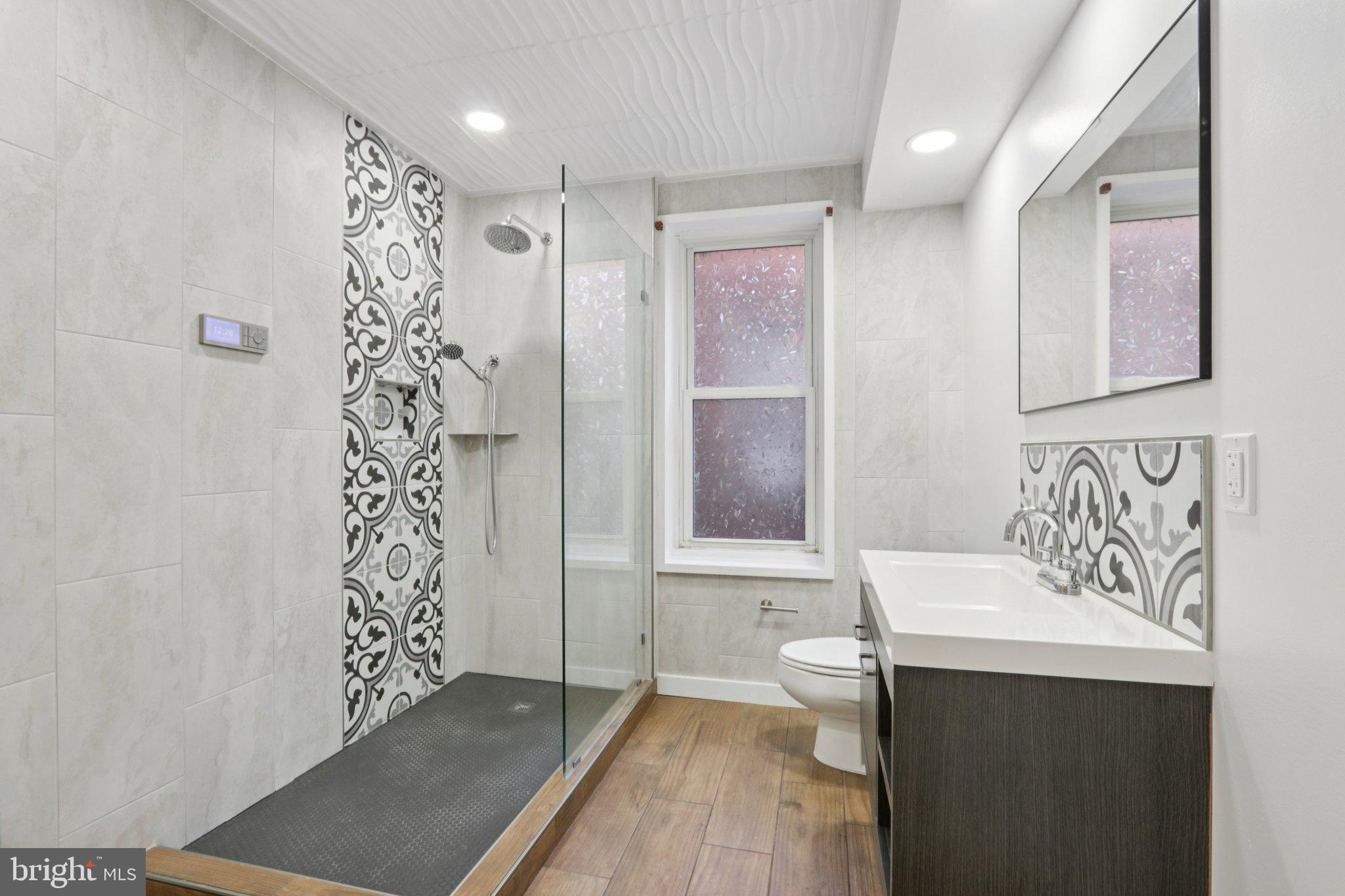 508 South 49th Street Philadelphia, PA 19143 - Photo 39 of 51 a bathroom with a sink a toilet and shower