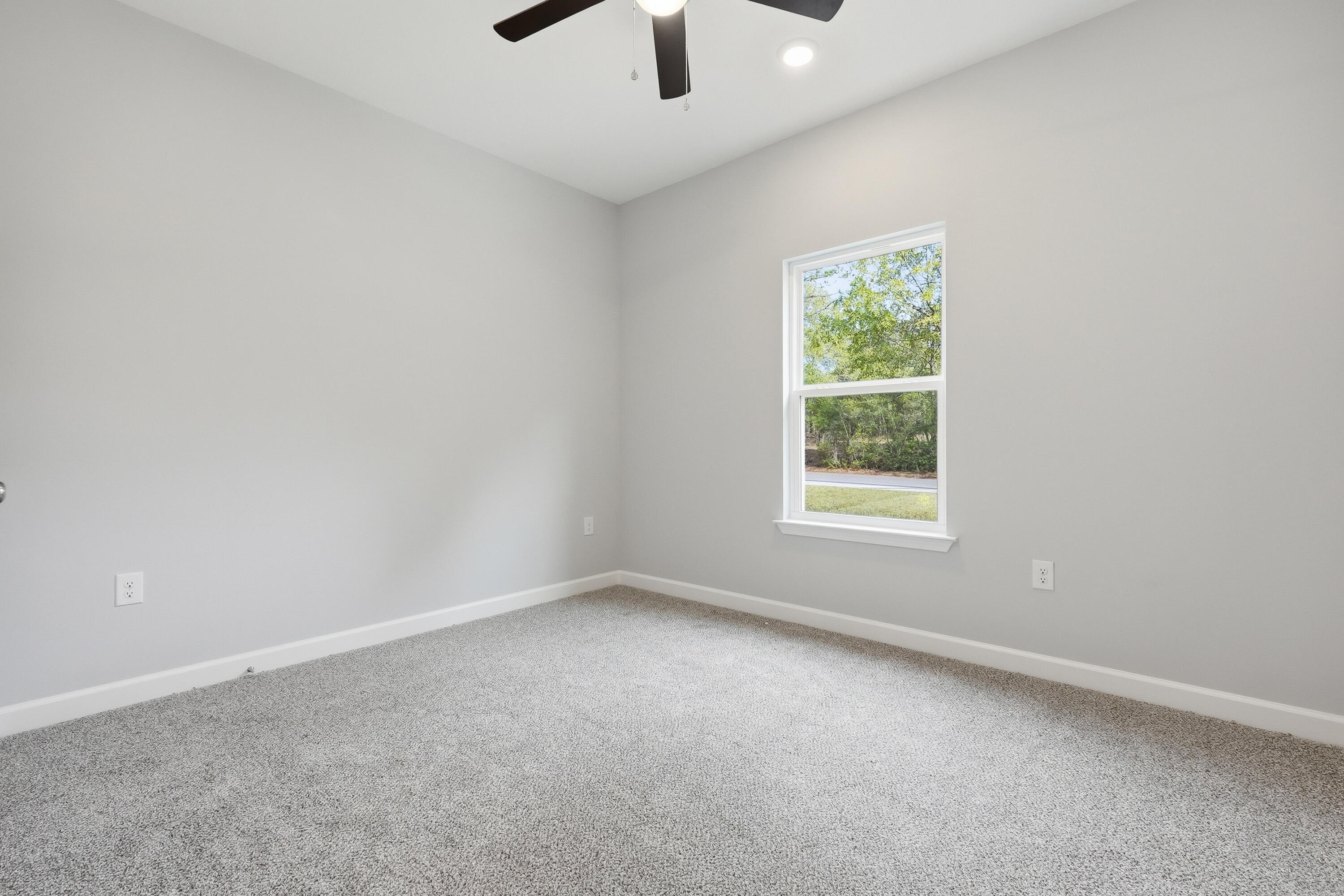 2588 Kingston Road Crestview, FL 32536 - Photo 16 of 23 an empty room with windows and fan