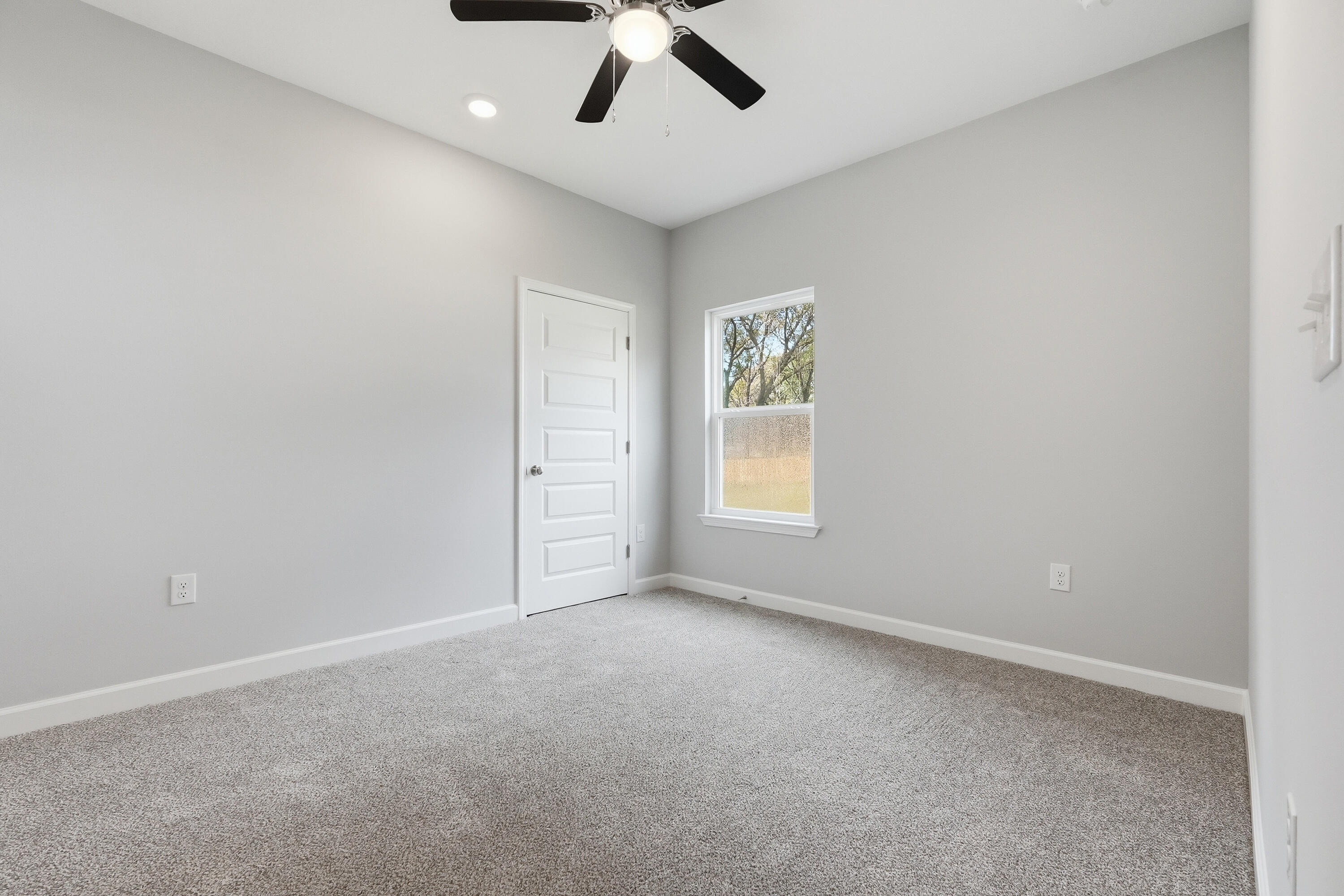 2588 Kingston Road Crestview, FL 32536 - Photo 18 of 23 an empty room with a window and ceiling fan