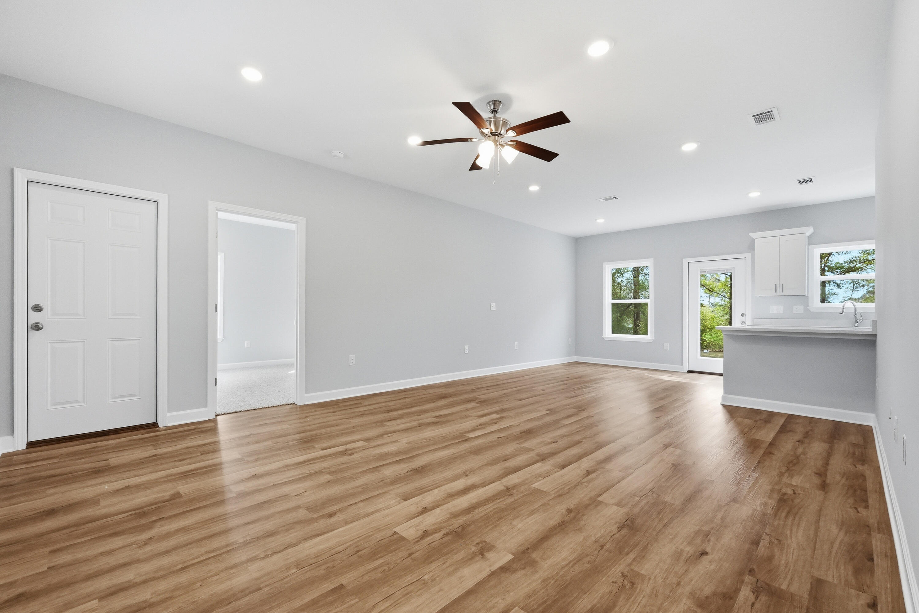 2588 Kingston Road Crestview, FL 32536 - Photo 3 of 23 a view of an empty room with window and wooden floor
