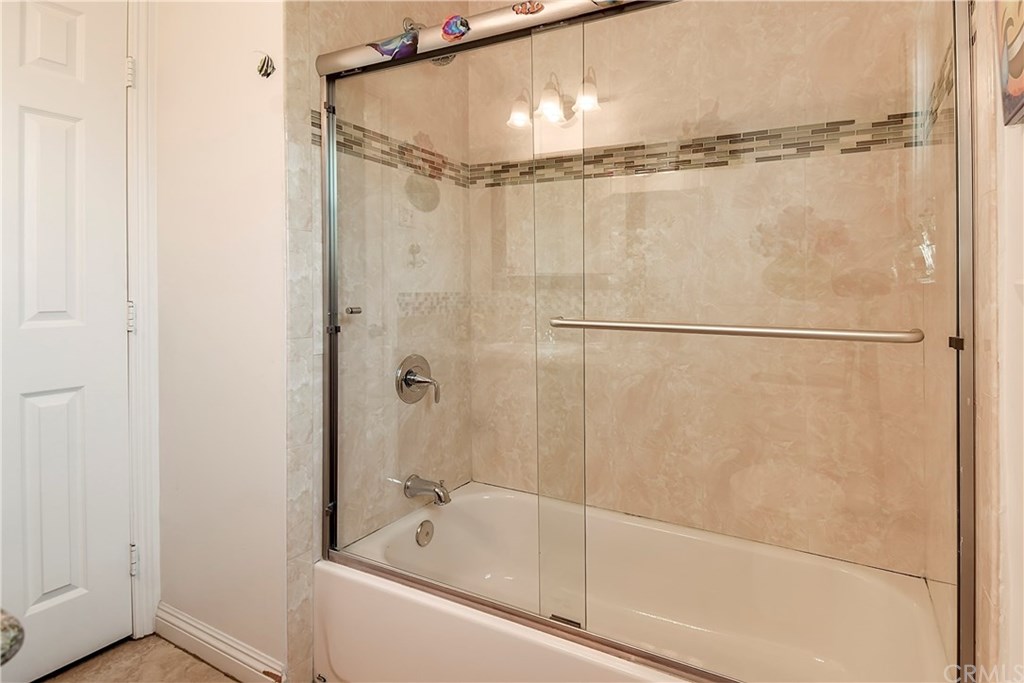 7863 Lyndora Street Downey, CA 90242 - Photo 16 of 27 a bathroom with a shower and a bath tub