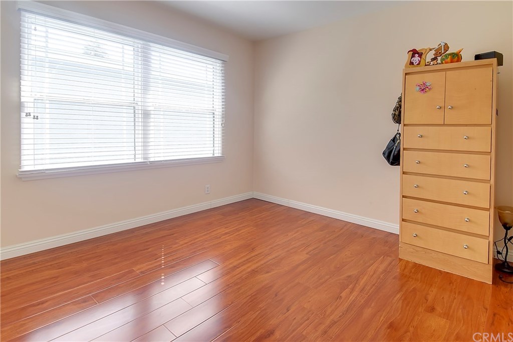 7863 Lyndora Street Downey, CA 90242 - Photo 17 of 27 a view of a room with wooden floor and window