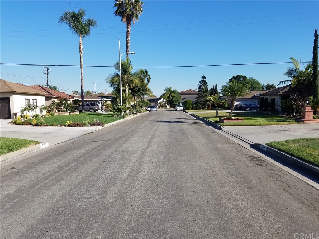 7863 Lyndora Street Downey, CA 90242 - Photo 25 of 27 a view of a house with a swimming pool and a yard