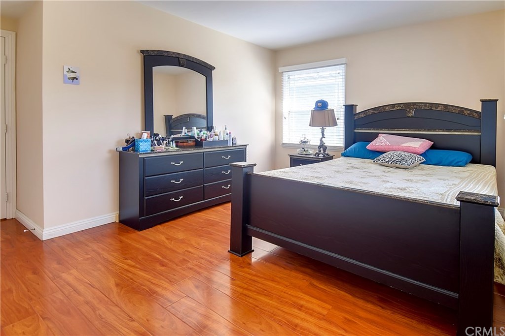 7863 Lyndora Street Downey, CA 90242 - Photo 8 of 27 a bedroom with a bed and a mirror on dresser