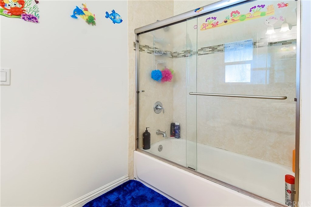7863 Lyndora Street Downey, CA 90242 - Photo 10 of 27 a bathroom with a bathtub and a shower