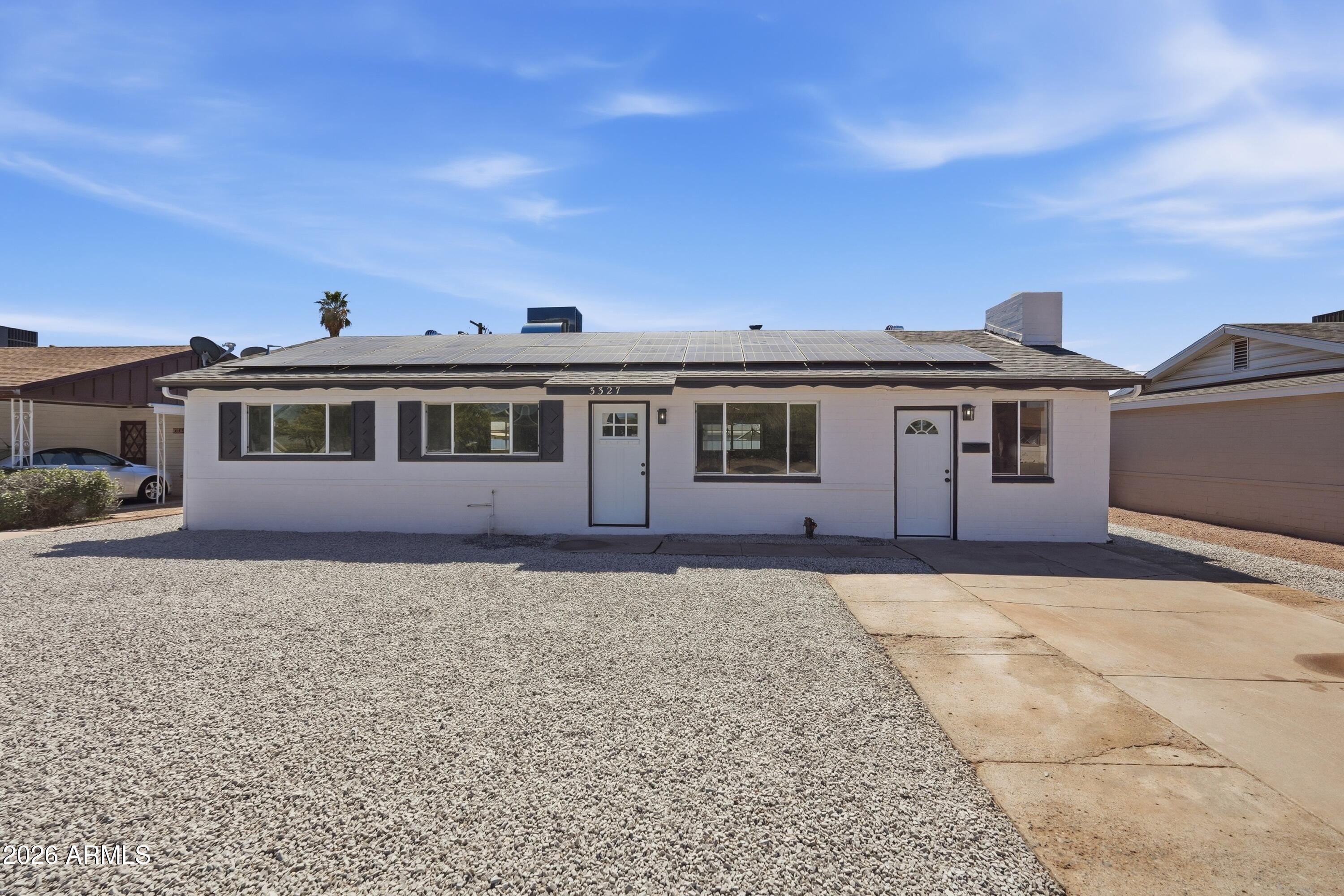 3327 West Wethersfield Road Phoenix, AZ 85029 - Photo 15 of 30 a front view of a house with a garden