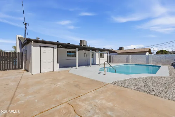 a view of a house with a backyard