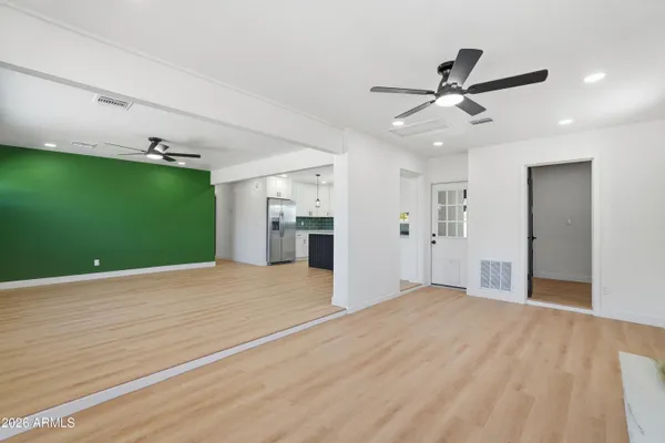 a view of a livingroom with a ceiling fan and entryway