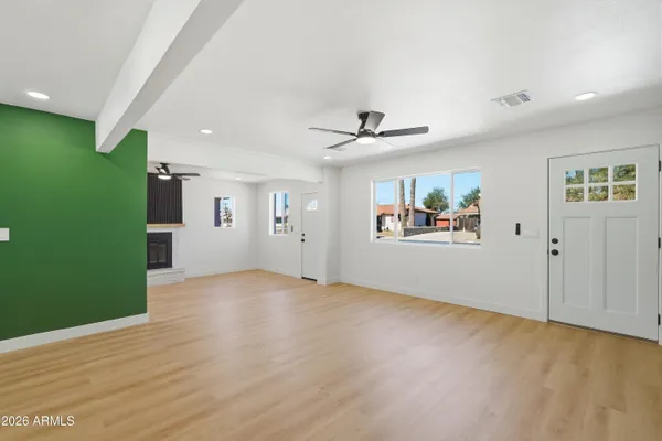 wooden floor in an empty room with a window