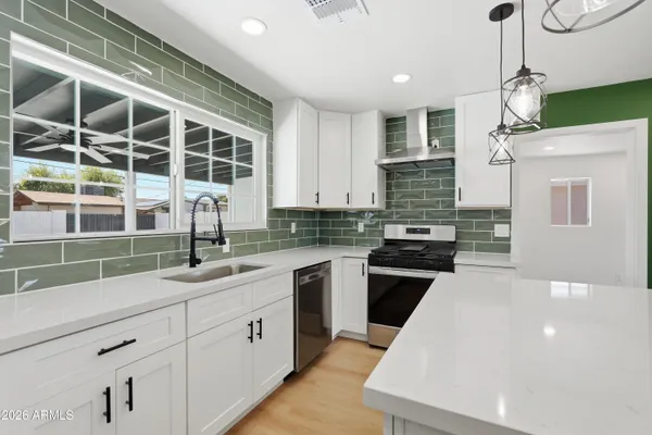 a kitchen with a sink and a stove top oven