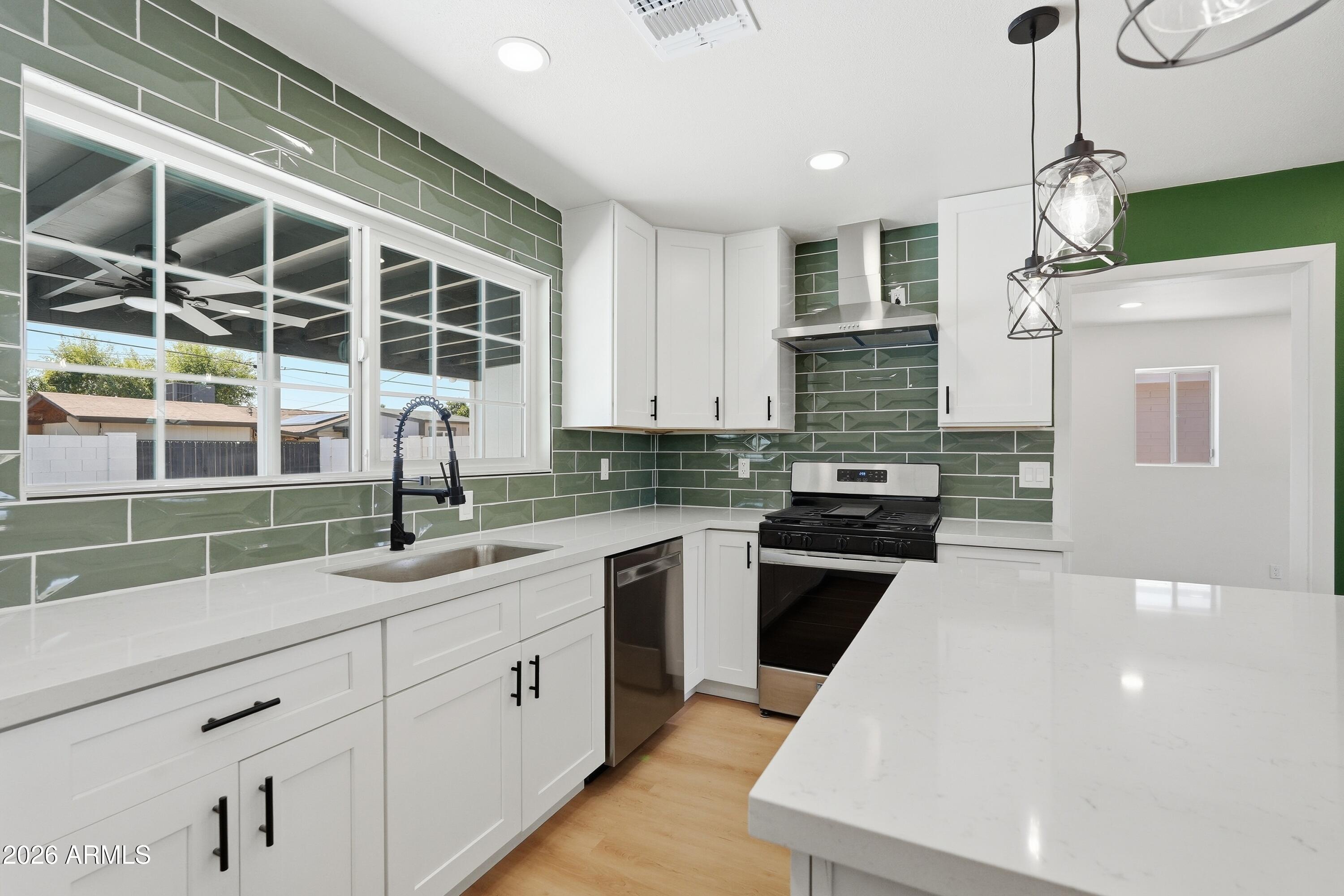 3327 West Wethersfield Road Phoenix, AZ 85029 - Photo 8 of 30 a kitchen with a sink and a stove top oven
